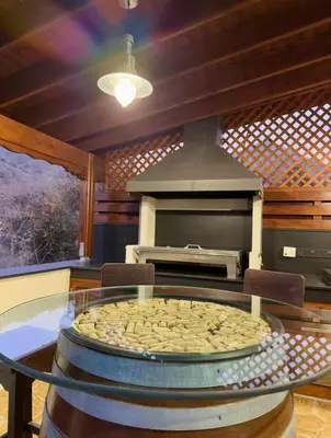 a pizza sitting on a glass table in a kitchen at To Petrino 5 -Apartment- Nature, Comfort & Tradition Under One Roof in Kalopanayiotis