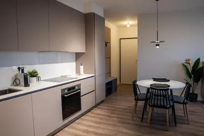 a kitchen with a table and chairs in a room at Luxe One Residence in Aglantzia