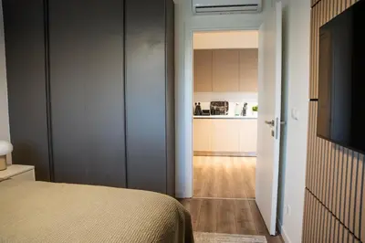 a bedroom with a bed and a kitchen at Luxe One Residence in Aglantzia