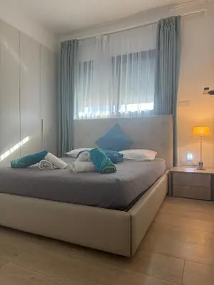 a bedroom with a bed with two towels on it at The Qube Residence 2 Bedroom Premium Apartment in Limassol