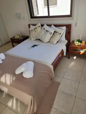 a bedroom with a large bed with towels on it at Ayia Napa Marina Luxury Villas - Sapphire in Ayia Napa