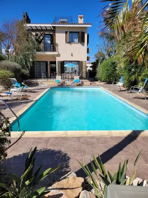 a swimming pool in front of a house at Ayia Napa Marina Luxury Villas - Sapphire in Ayia Napa