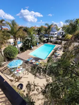 an overhead view of a swimming pool with chaise lounges at Ayia Napa Marina Luxury Villas - Sapphire in Ayia Napa