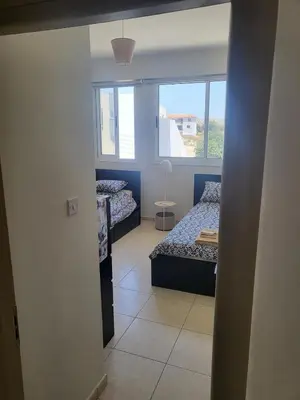 two beds in a room with a window at Sea View Valley Retreat in Voroklini