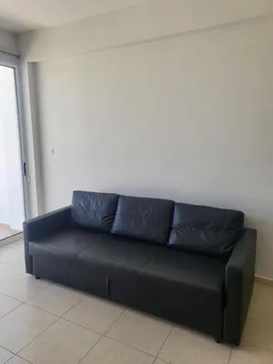 a black leather couch sitting in a room at Sea View Valley Retreat in Voroklini