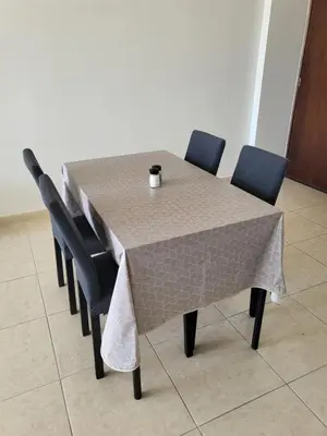 a table with chairs and a table cloth on it at Sea View Valley Retreat in Voroklini