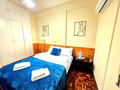 a hotel room with a bed with blue sheets and towels at Breathtaking Beachfront Apartment in Makenzy in Larnaka