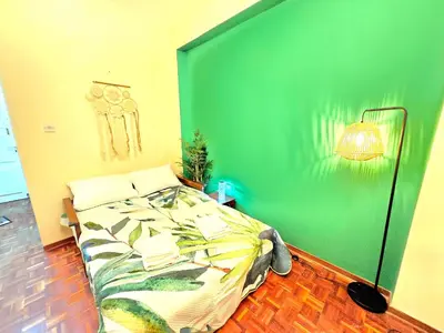 a bedroom with a bed and a green wall at Breathtaking Beachfront Apartment in Makenzy in Larnaka