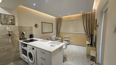 a kitchen with a washer and dryer in a room at STAY Fantasia Central Suite in Nicosia