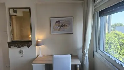 a room with a table and a mirror and a window at STAY Fantasia Central Suite in Nicosia