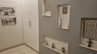 a hallway with a cross on the wall and a cross on a shelf at STAY Fantasia Central Suite in Nicosia