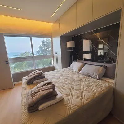 a bedroom with a bed with towels on it at Amato Beach in Limassol