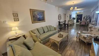 a living room with two couches and a table at STAY Vintage Central Suite in Nicosia
