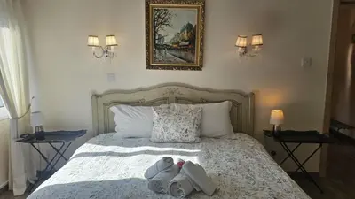 a bedroom with a bed with towels on it at STAY Vintage Central Suite in Nicosia