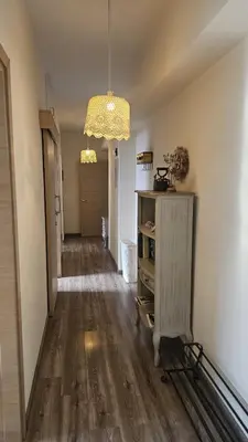 a hallway with a wooden floor and a chandelier at STAY Vintage Central Suite in Nicosia