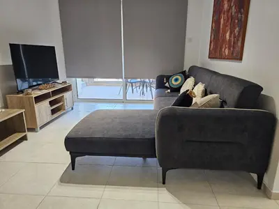 a living room with a couch and a tv at Horizon View 2 in Kiti