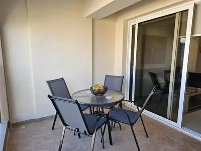a table with chairs and a bowl of fruit on it at Horizon View 2 in Kiti