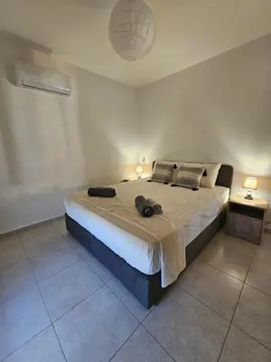 a bedroom with a large bed with two pillows at Horizon View 2 in Kiti