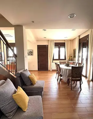 a living room with a couch and a table at Kyperounta Heights - Breathtaking View in Kyperounda