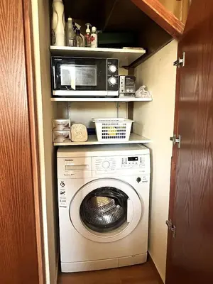 a kitchen with a washing machine and a microwave at Kyperounta Heights - Breathtaking View in Kyperounda