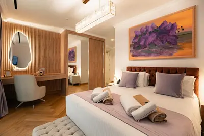 a bedroom with a large bed with towels on it at Averde Residence in Larnaka