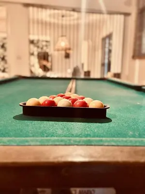 a tray of balls on top of a pool table at The Lodge Kampi by Thea Suites