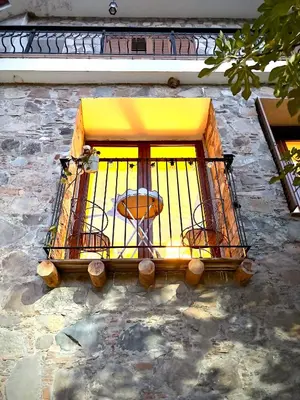 a balcony with a table in a window at The Lodge Kampi by Thea Suites