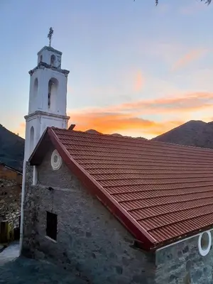 a church with a tower and a red roof at The Lodge Kampi by Thea Suites