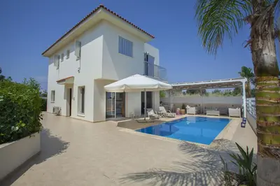 a villa with a swimming pool and a house at Villa Posidonas 3 in Protaras