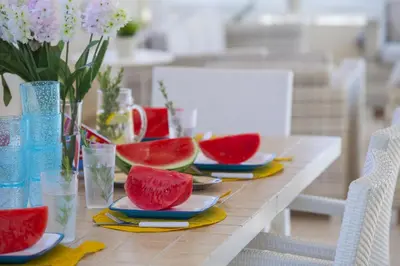 a table with plates of watermelon on top of it at Villa Posidonas 3 in Protaras