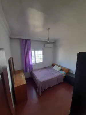 a small bedroom with a bed and a window at Daire in Kaimakli