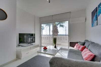 a living room with a couch and a tv at Elisabeth Salt Lake views 200m from Makenzy beach in Larnaka