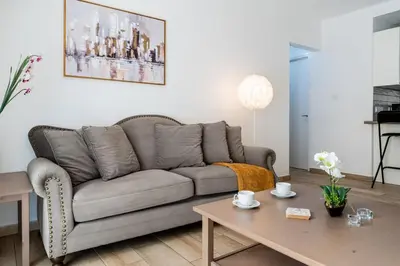 a living room with a couch and a coffee table at Levante - 2-BR Apt & Terrace in Larnaca in Larnaka