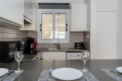 a kitchen with two empty wine glasses on a counter at Levante - 2-BR Apt & Terrace in Larnaca in Larnaka