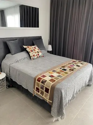 a bedroom with a bed with a quilt on it at CoveDream Studio Sun Valley Esentepe in Aglantzia