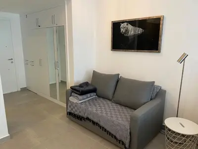 a living room with a couch and a picture on the wall at CoveDream Studio Sun Valley Esentepe in Aglantzia