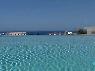 a large pool of water with buildings in the background at CoveDream Studio Sun Valley Esentepe in Aglantzia
