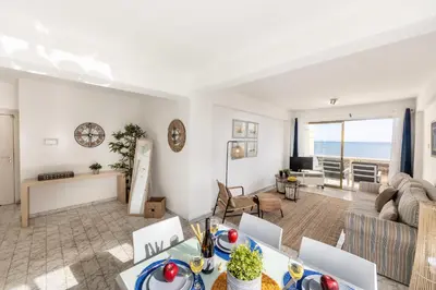 a living room with a view of the ocean at Mackenzie Beachfront Suite in Larnaka