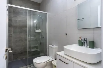 a bathroom with a toilet and a sink and a shower at Azoria - Stylish 1-BR Apartment & Balcony in Kiti in Kiti
