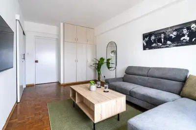 a living room with a couch and a coffee table at Bastia - Skyline 1-BR Apt & Balcony in Nicosia in Nicosia