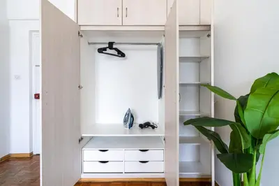 a room with white shelves and a plant at Bastia - Skyline 1-BR Apt & Balcony in Nicosia in Nicosia