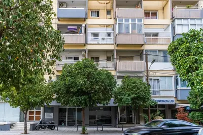 an apartment building with trees in front of it at Bastia - Skyline 1-BR Apt & Balcony in Nicosia in Nicosia