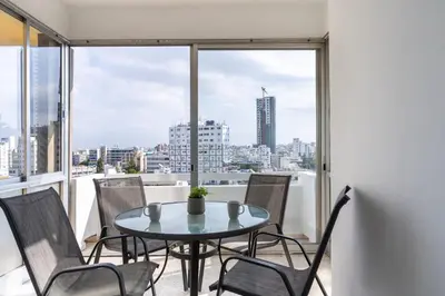 a table and chairs in a room with a window at Bastia - Skyline 1-BR Apt & Balcony in Nicosia in Nicosia