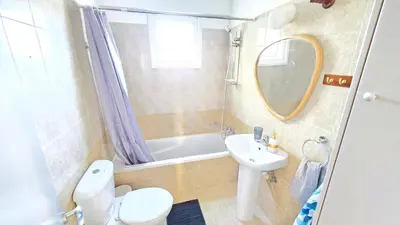 a bathroom with a sink and a toilet and a tub at 2BR Apartment with Pool & Free Wi-Fi in Larnaka