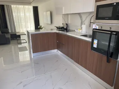 a kitchen with a sink and a counter top at Grand Sappfıre Resort Iskele in Larnaka