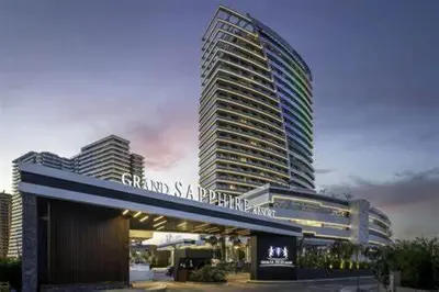 a tall building with a sign in front of it at Grand Sappfıre Resort Iskele in Larnaka