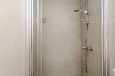 a shower with a glass door in a bathroom at Urban Bay Studios in Limassol