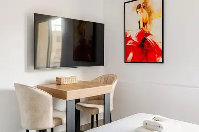 a dining room with a table and two chairs at Urban Bay Studios in Limassol