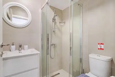 a bathroom with a shower and a toilet and a sink at Urban Bay Studios in Limassol