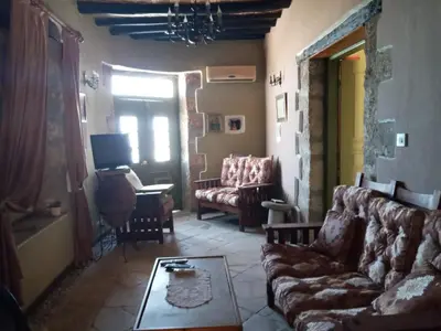 a living room with a couch and a table at Historic 600 years old beautifully renovated Mill House in Meniko